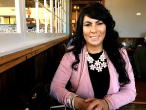Brandie de la Rosa, CEO of E3inspire, smiling in a professional restaurant setting